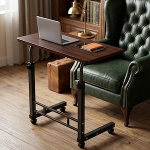 May include: A mobile laptop desk with a dark brown wood-grain rectangular top and a black metal frame. The desk features adjustable height settings with visible knobs and four small caster wheels at the base for movement across the floor.
