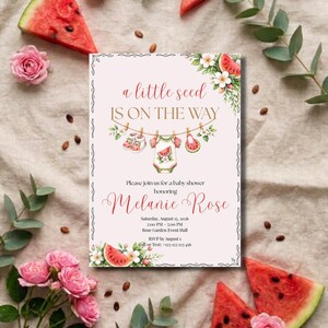 May include: A rectangular baby shower invitation card with a light pink background featuring watermelon slices, pink roses, and eucalyptus leaves. The text reads: a little seed IS ON THE WAY, honoring Melanie Rose, Saturday, August 15, 2026.