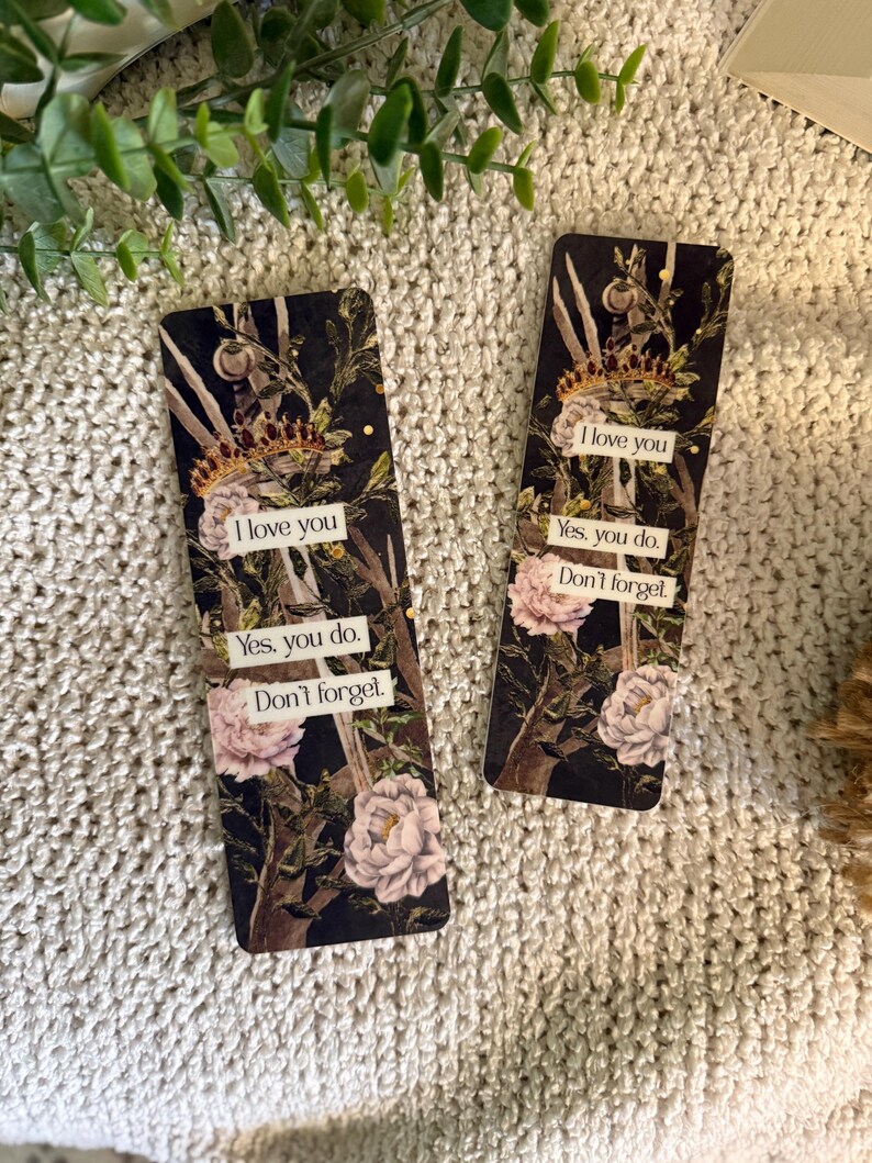 May include: Two rectangular bookmarks featuring a dark floral design with white peonies, branches, and a gold crown. Each bookmark displays the text: I love you, Yes, you do, Don't forget, printed on white rectangular labels against the dark background.