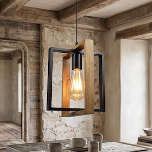 May include: A square pendant light fixture featuring a combination of black metal and natural wood frames. The fixture hangs from a black ceiling canopy by a thin cord and contains a single exposed Edison-style light bulb emitting a warm glow.