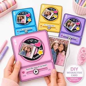 May include: Four interactive cards shaped like music players in blue, yellow, purple, and pink. Each card features a central circular graphic with a photo, a heart, a star, and text reading I Love you so, BFF, and My melody. Playback bars show text.