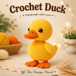 May include: A yellow crochet duck toy with an orange beak and feet, black eyes, and pink blush marks. The text "Crochet Duck" and "Handmade with Love" appears above the duck, and "The Design Hand" is printed on a label at the bottom.