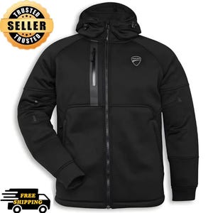 May include: A black hooded jacket featuring a full-length front zipper, a vertical zippered chest pocket, and a small white Ducati logo on the upper left chest. The garment includes long sleeves with ribbed cuffs and an adjustable drawstring hood.