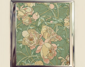 May include: A silver cigarette case featuring a floral design. The design incorporates pink and yellow flowers with green leaves on a green background.