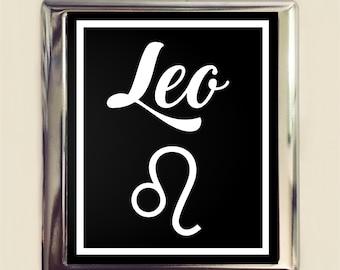 May include: A silver metal frame with a black background and white text that says "Leo" and the astrological symbol for Leo.