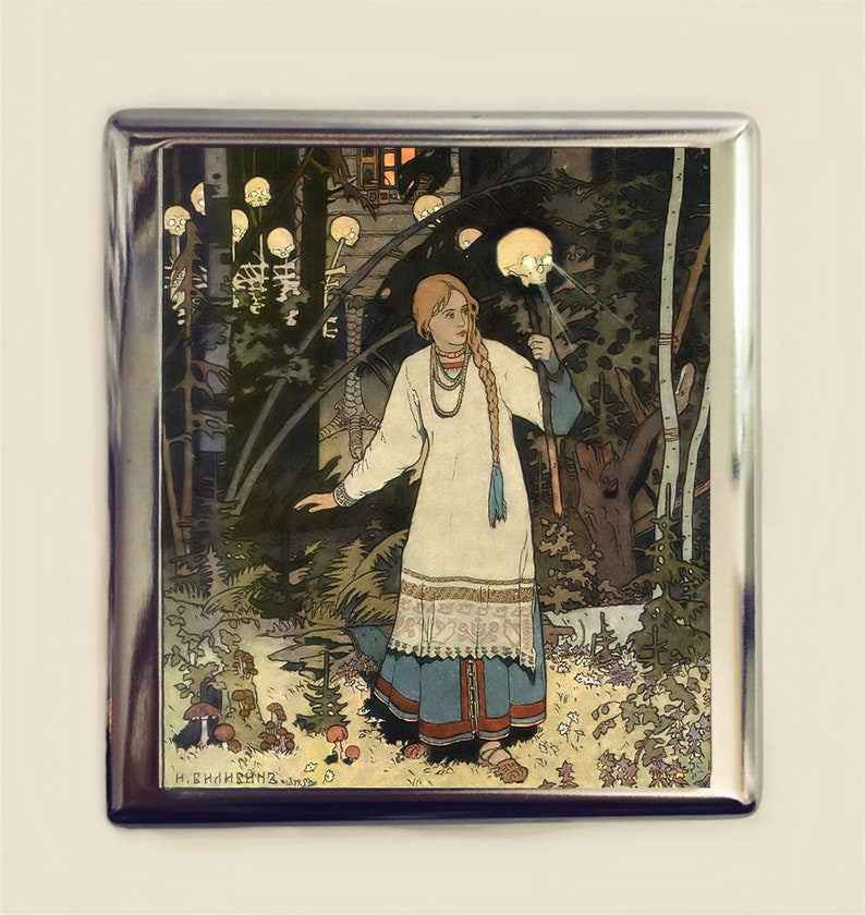 May include: A woman in a white dress with blue embroidery stands in a dark forest. She holds a glowing skull in her hand. The forest is filled with glowing skulls and mushrooms.