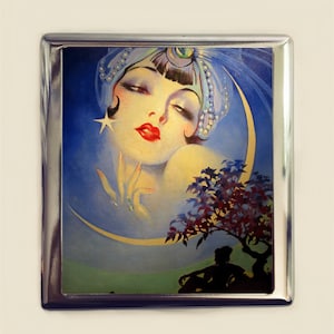 May include: A vintage illustration of a woman with a blue turban and a crescent moon behind her. The woman has dark hair and red lips. The background is a blue sky with stars.
