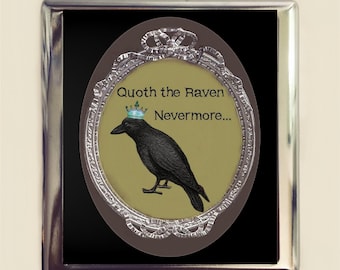 May include: A black and silver framed oval picture with a black raven wearing a blue crown. The raven is perched on a yellow background. The text "Quoth the Raven Nevermore..." is written in black lettering.