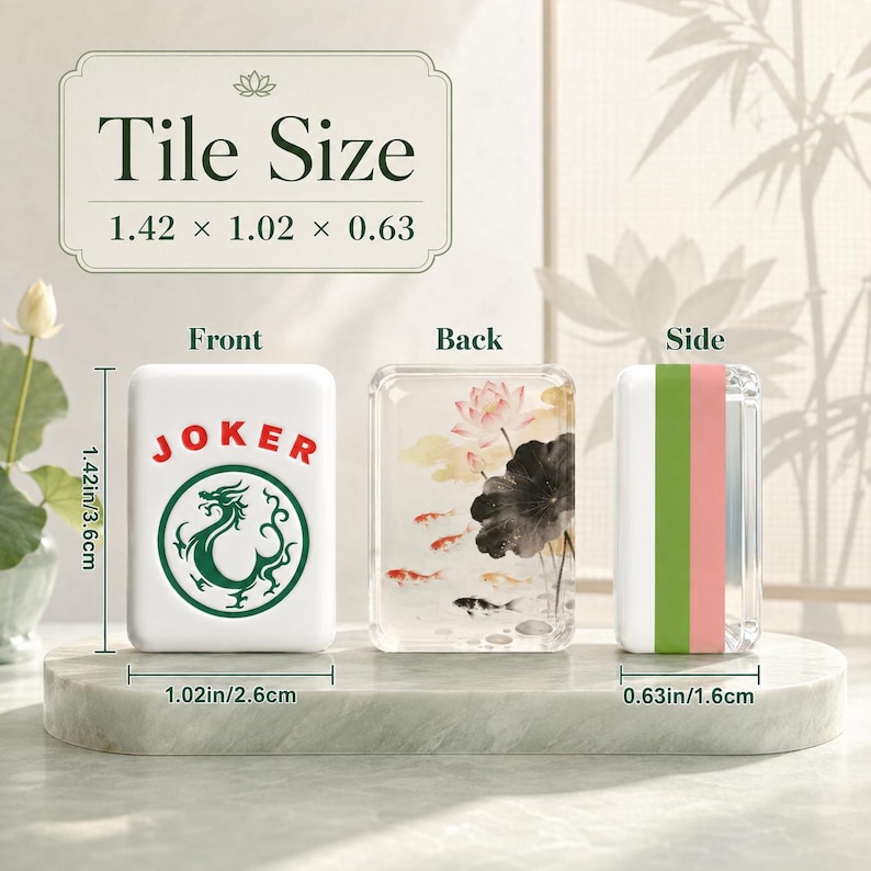 May include: A Mahjong tile shown from the front, back, and side. The front is white with a green dragon graphic and the red text JOKER. The back features a lotus and koi fish illustration. Dimensions are 1.42 inches by 1.02 inches by 0.63 inches.