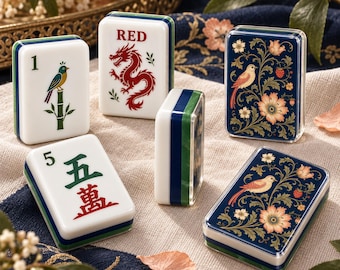 May include: A set of rectangular Mahjong tiles featuring various designs including a bird on bamboo, a red dragon with the text RED, the Chinese character for five, and intricate floral patterns with birds in blue, white, and green.