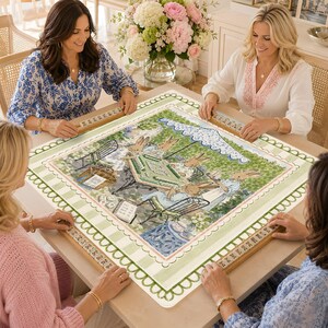 May include: A square mahjong table cover featuring a central illustration of rabbits playing a game outdoors under a blue and white scalloped umbrella. The border has a light green and white striped pattern with a scalloped edge design.