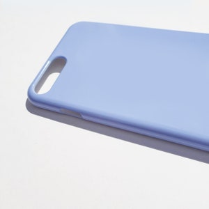 May include: A light blue phone case made of a smooth, hard plastic material.