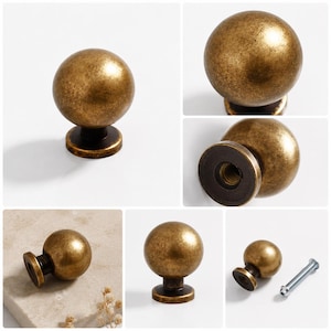 May include: A spherical cabinet knob with a distressed antique brass finish. The knob features a smooth, rounded top and a cylindrical base with a threaded interior hole. A separate metal mounting screw is included for installation purposes.