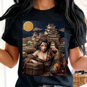 May include: A black t-shirt featuring a graphic print of a person in traditional attire with an ornate hairstyle, resting a hand on a rectangular chest. The background depicts a Japanese-style castle under a large yellow moon and starry sky.