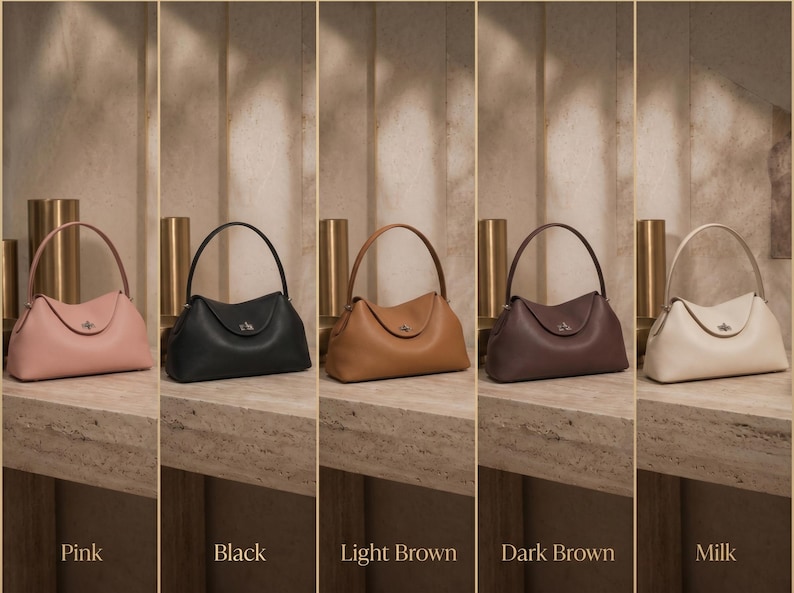 May include: Five structured handbags with a single top handle and a central metal turn-lock closure. The bags are displayed in a row in colors labeled as pink, black, light brown, dark brown, and milk, each featuring a smooth, curved silhouette.