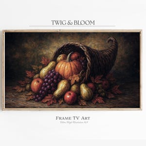 May include: A framed digital art print featuring a cornucopia overflowing with autumn harvest. The image includes a pumpkin, grapes, pears, and apples in a warm color palette. The text "TWIG & BLOOM" and "FRAME TV ART" are displayed.