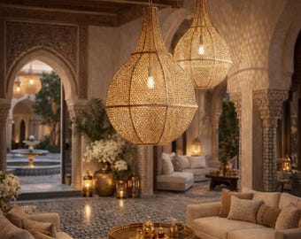 May include: Two large, teardrop-shaped pendant lights made of woven natural fiber mesh hang from the ceiling. The fixtures feature a light tan color and a grid-like texture, casting a warm, soft glow throughout the interior living space.