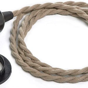 May include: A black electrical cord with a beige braided fabric covering. The cord has a black electrical socket and a matching black ceiling plate.