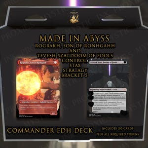 May include: A black rectangular box containing a Commander EDH deck titled Made in Abyss. The box displays two game cards, Rograkh, Son of Rohgahh and Tevesh Szat, Doom of Fools, with text detailing a control and stax strategy for bracket 5.