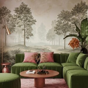 May include: A green velvet sectional sofa and matching ottoman paired with a round wooden coffee table. The room features a wall mural depicting a forest landscape, a copper floor lamp, and a pink patterned area rug with pink throw pillows.