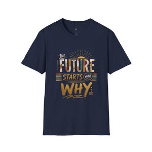 May include: A navy blue short-sleeve t-shirt featuring a graphic design with the text "THE FUTURE STARTS WITH WHY" in a mix of white, orange, and yellow colors, accented by sunburst lines and horizontal stripes in a retro-inspired style.