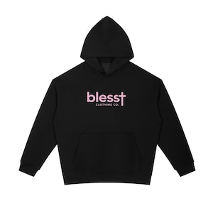 May include: A black hooded sweatshirt featuring a front kangaroo pocket and long sleeves. The chest displays the text "blesst" in light pink, with the letter "t" stylized as a cross, followed by the words "CLOTHING CO." in smaller white text.