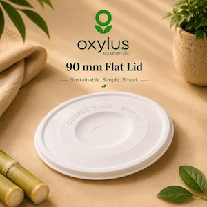 May include: A white circular 90 mm flat lid with the embossed text COMPOSTABLE and 90mm 90. The branding above includes the green oxylus ecogreen LLC logo and the text 90 mm Flat Lid with the tagline Sustainable. Simple. Smart. printed in dark green.
