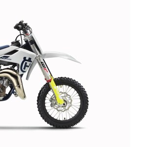 May include: A white Husqvarna TC 65 motocross motorcycle manual titled REPARATURANLEITUNG 2020. The cover features a side view of the white bike with yellow fork guards, black knobby tyres, and the Husqvarna logo. Includes model TC 65 and Art.-Nr. 3403100de.
