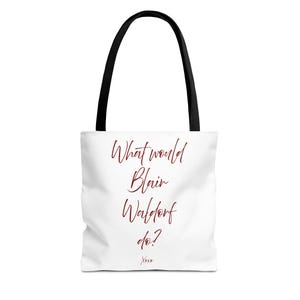 May include: A white tote bag with black handles featuring the dark red text What would Blair Waldorf do? printed in a cursive script on the front, with the word Xoxo printed in a smaller cursive script at the bottom center of the bag.