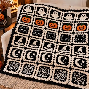 May include: A handmade crochet blanket featuring a grid of square motifs with Halloween-themed designs including white ghosts, orange pumpkins, black cats, witch hats, crescent moons with stars, and white spiderwebs on a black background.