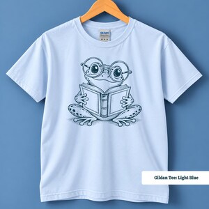 Book lover shirt with an adorable hand sketched frog in big round glasses enjoying an open book, cute frog shirt, book club sweatshirt, reading shirt, frog reading shirt, bookish shirt, book club shirt, library shirt, book lover gift, frog lover gift, frog sweatshirt, bookish sweatshirt, comfort colors shirt, reader shirt, bookworm gift, reading lover gift, librarian gift, book club gift, cute frog shirt for readers, frog gift