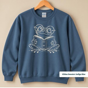 Comfort colors shirt featuring a cute sketch style frog with oversized circular glasses reading an open book, cute frog shirt, book club sweatshirt, book lover shirt, reading shirt, frog reading shirt, bookish shirt, book club shirt, library shirt, book lover gift, frog lover gift, frog sweatshirt, bookish sweatshirt, bookworm shirt, reader gift, book club gift, reading lover shirt, librarian gift, cute frog gift, bookish frog tee