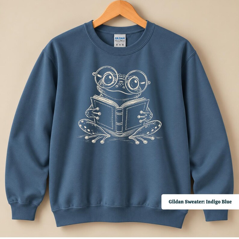 Comfort colors shirt featuring a cute sketch style frog with oversized circular glasses reading an open book, cute frog shirt, book club sweatshirt, book lover shirt, reading shirt, frog reading shirt, bookish shirt, book club shirt, library shirt, book lover gift, frog lover gift, frog sweatshirt, bookish sweatshirt, bookworm shirt, reader gift, book club gift, reading lover shirt, librarian gift, cute frog gift, bookish frog tee