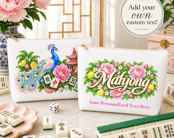 May include: Two white zippered pouches featuring colorful illustrations of a peacock, pink peonies, and mahjong tiles. One pouch displays the word Mahjong in script with floral accents and the text Your Personalized Text Here below it.