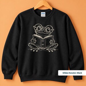 Bookish sweatshirt featuring a cute hand sketched frog wearing big round glasses and enjoying a book, cute frog shirt, book club sweatshirt, book lover shirt, reading shirt, frog reading shirt, bookish shirt, book club shirt, library shirt, book lover gift, frog lover gift, frog sweatshirt, comfort colors shirt, bookworm gift, reader shirt, reading lover gift, librarian gift, book club gift, cute frog tee, bookish gift