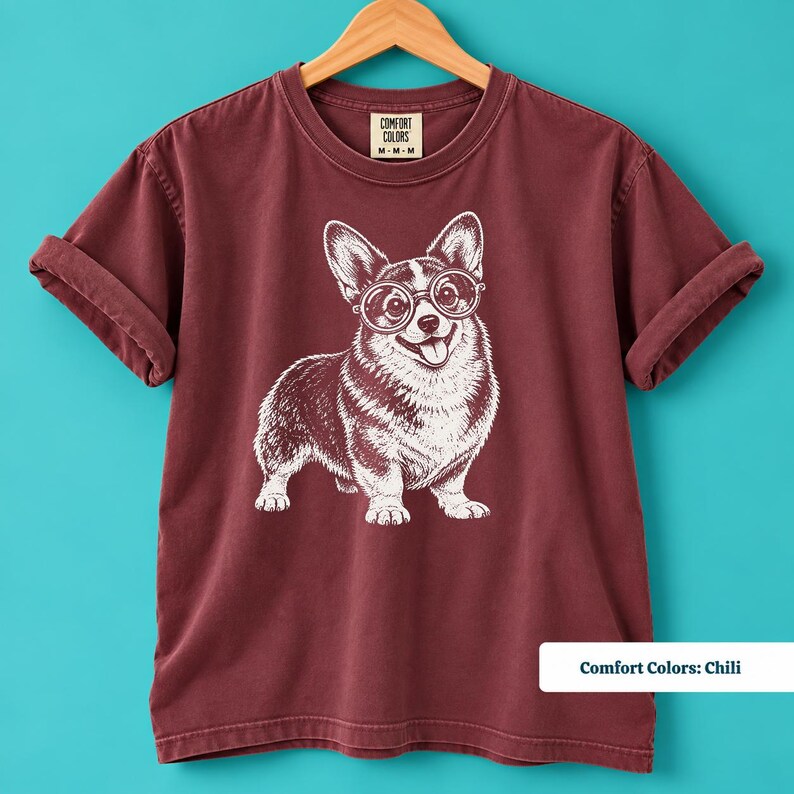 A corgi shirt and corgi merchandise design showcasing a cute glasses-wearing corgi with a vintage inspired look. This corgi glasses shirt combines the charm of a retro corgi shirt with a geeky corgi shirt, creating a fun vintage dog tee for corgi moms and dog lovers.