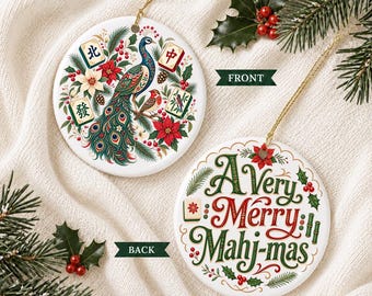 May include: Two round white ceramic ornaments with gold hanging strings. The front features a colorful peacock, poinsettias, pine branches, and mahjong tiles. The back displays the text A Very Merry Mahj-mas in green and red decorative script.