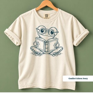 Book club shirt featuring a cute hand drawn frog with big circular glasses reading a book, cute frog shirt, book club sweatshirt, book lover shirt, reading shirt, frog reading shirt, bookish shirt, library shirt, book lover gift, frog lover gift, frog sweatshirt, bookish sweatshirt, comfort colors shirt, book club gift, reader gift, bookworm shirt, reading lover shirt, librarian gift, cute bookish shirt, frog reader gift