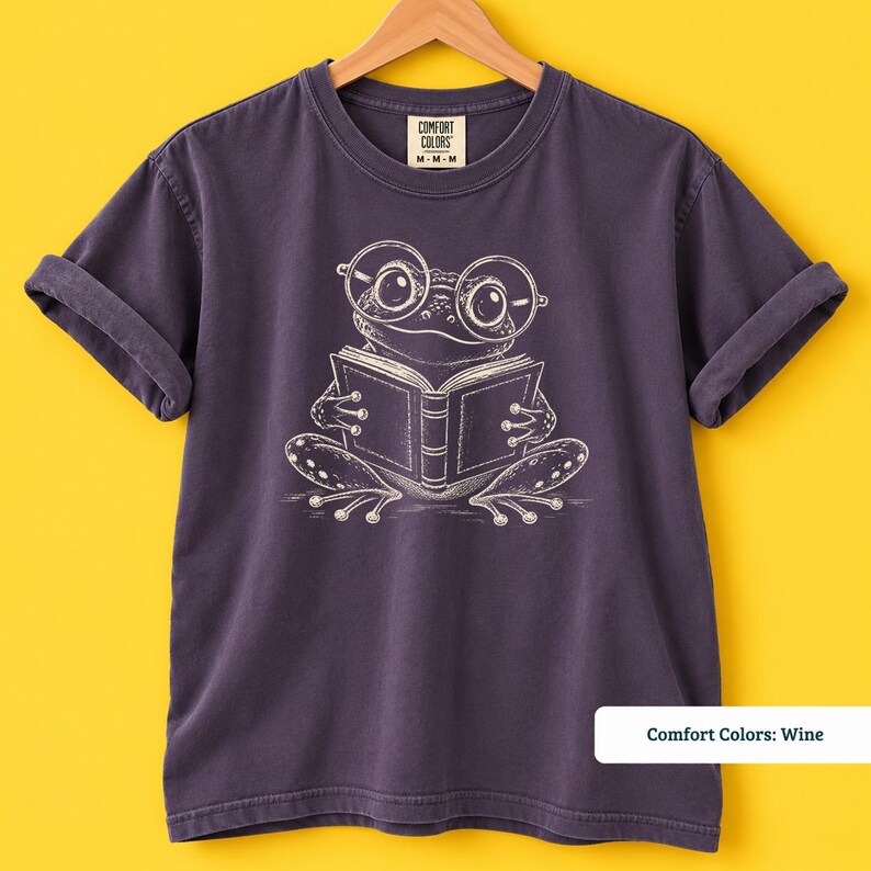 Frog reading shirt featuring a charming hand sketched frog with large round eyeglasses holding an open book, cute frog shirt, book club sweatshirt, book lover shirt, reading shirt, bookish shirt, book club shirt, library shirt, book lover gift, frog lover gift, frog sweatshirt, bookish sweatshirt, comfort colors shirt, bookworm shirt, reader gift, cute frog tee, reading lover shirt, librarian gift, book club gift, bookish reader shirt