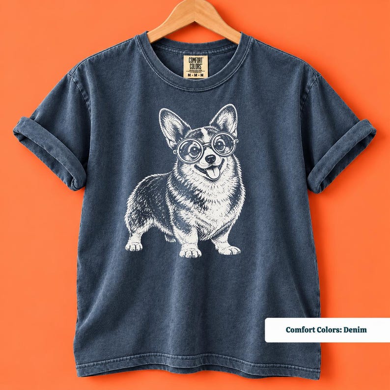 This corgi shirt and corgi merchandise design features a cute nerdy corgi wearing glasses with a vintage inspired graphic style. Perfect for anyone searching for a corgi nerd shirt, geeky corgi shirt, retro corgi shirt, corgi mom shirt, or fun vintage dog tee.