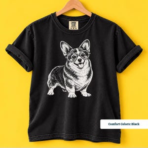 A corgi shirt and corgi merchandise mockup featuring a sweet corgi with glasses for dog lovers who enjoy quirky vintage designs. The corgi glasses shirt has the personality of a geeky corgi shirt and retro corgi shirt while also making a fun nerdy dog shirt or corgi mom gift.