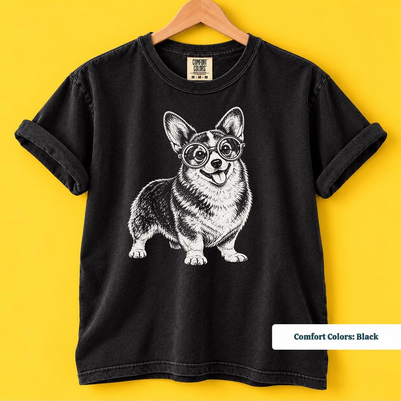 A corgi shirt and corgi merchandise mockup featuring a sweet corgi with glasses for dog lovers who enjoy quirky vintage designs. The corgi glasses shirt has the personality of a geeky corgi shirt and retro corgi shirt while also making a fun nerdy dog shirt or corgi mom gift.