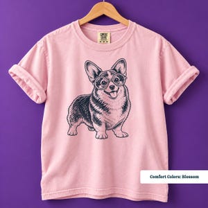 A corgi shirt and corgi merchandise design featuring an expressive corgi with glasses in a quirky retro aesthetic. This vintage corgi shirt works perfectly for fans of geeky corgi shirts and corgi nerd shirts while giving the classic vintage dog tee a playful new personality.