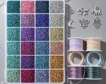 May include: A clear plastic storage container filled with twenty-four compartments of small colorful seed beads in shades of teal, pink, blue, silver, and gold. Beside the container are six silver metal charms and four spools of colored cord.