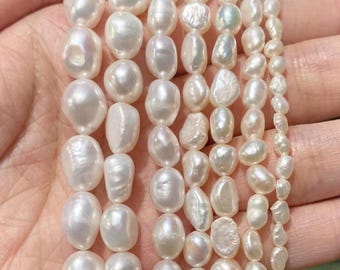 May include: Six strands of white freshwater pearls arranged by size, ranging from 4 to 10mm in diameter. Each strand features irregular, organic-shaped pearls with a lustrous, iridescent finish, displayed in a vertical orientation.