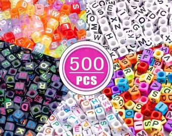 May include: A collection of 500 square alphabet beads in various styles, including translucent multicolored, solid white with black letters, solid black with multicolored letters, and white with multicolored letters, featuring a central 500 PCS label.