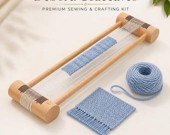 May include: A wooden weaving loom with white warp threads, a partially woven light blue section, a matching ball of light blue yarn, and a finished square light blue woven coaster with fringe. Text reads Debora Collectives.