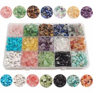 May include: A rectangular clear plastic storage container with fifteen compartments, each filled with different colored and textured gemstone chips. The collection includes rose quartz, green aventurine, tiger eye, lapis lazuli, amethyst, and clear quartz.