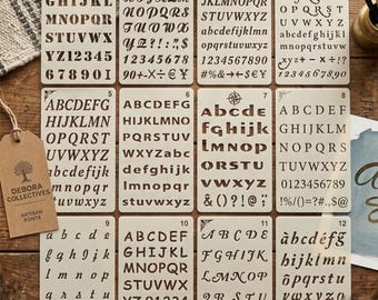 May include: A set of twelve rectangular off-white plastic stencils, each numbered one through twelve, featuring various alphabet letter styles, numbers, and symbols. The stencils are arranged in a grid, displaying diverse typography designs.