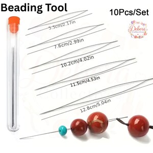 May include: A 10-piece set of silver beading needles in a clear storage tube with an orange cap. The needles are shown in five lengths: 2.17 inches, 2.99 inches, 4.02 inches, 4.53 inches, and 5.04 inches. One needle is threaded with turquoise and red beads.